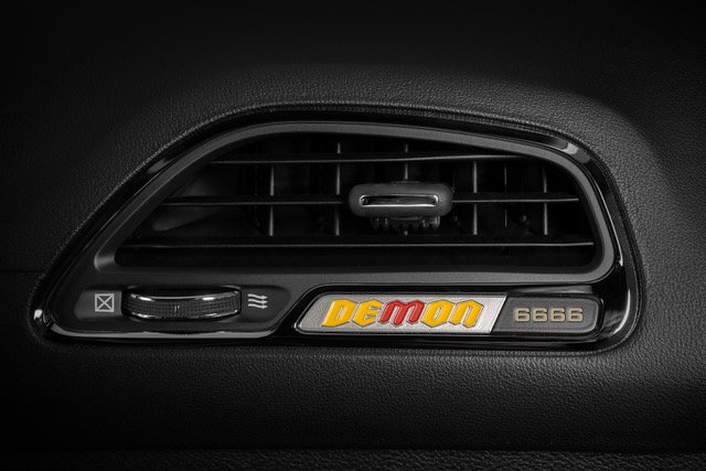 A yellow and red Demon instrument panel badge calls out the four-digit vehicle VIN number.